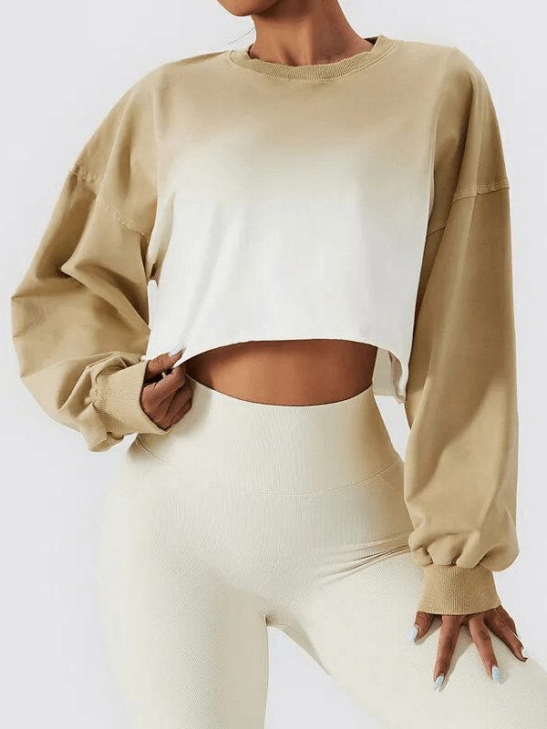 Stylish gradient color long sleeve O-neck crop top for women, perfect for active days, made from breathable cotton. Model poses confidently.